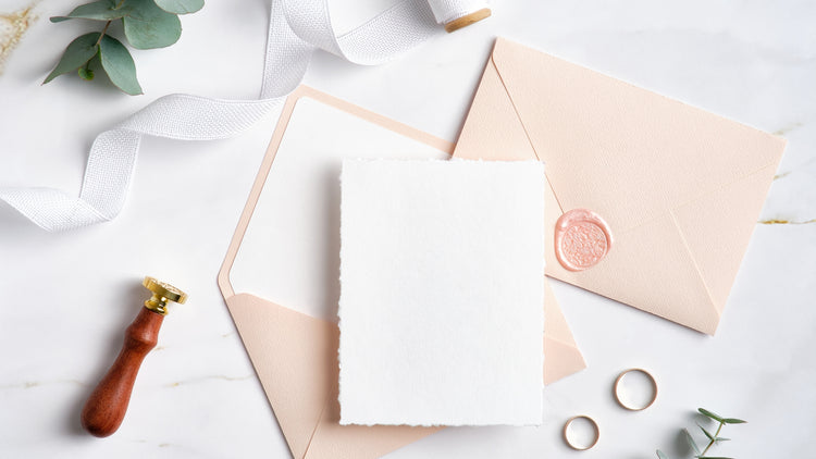 Wedding and bridal party gifts shown out of gift box include champagne, luxury throw.
