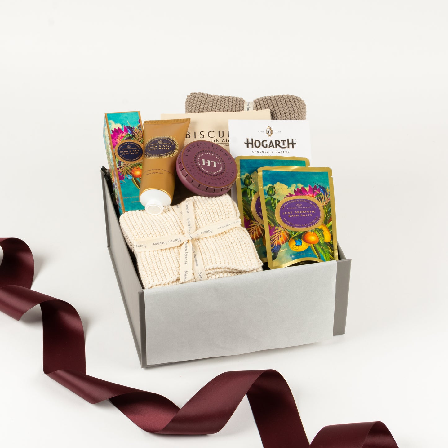 Spoil Her - Gift Boxes NZ - Gifts of Distinction. Featured in this gift box are a set of cotton washers and cotton towel, 2 bath salts, hand cream, tea by Harney and sons, almond biscuits and craft chocolate.