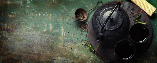 Ancient teapots on green background