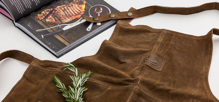 Most popular gift boxes for him containing a leather apron, bbq cookbook.