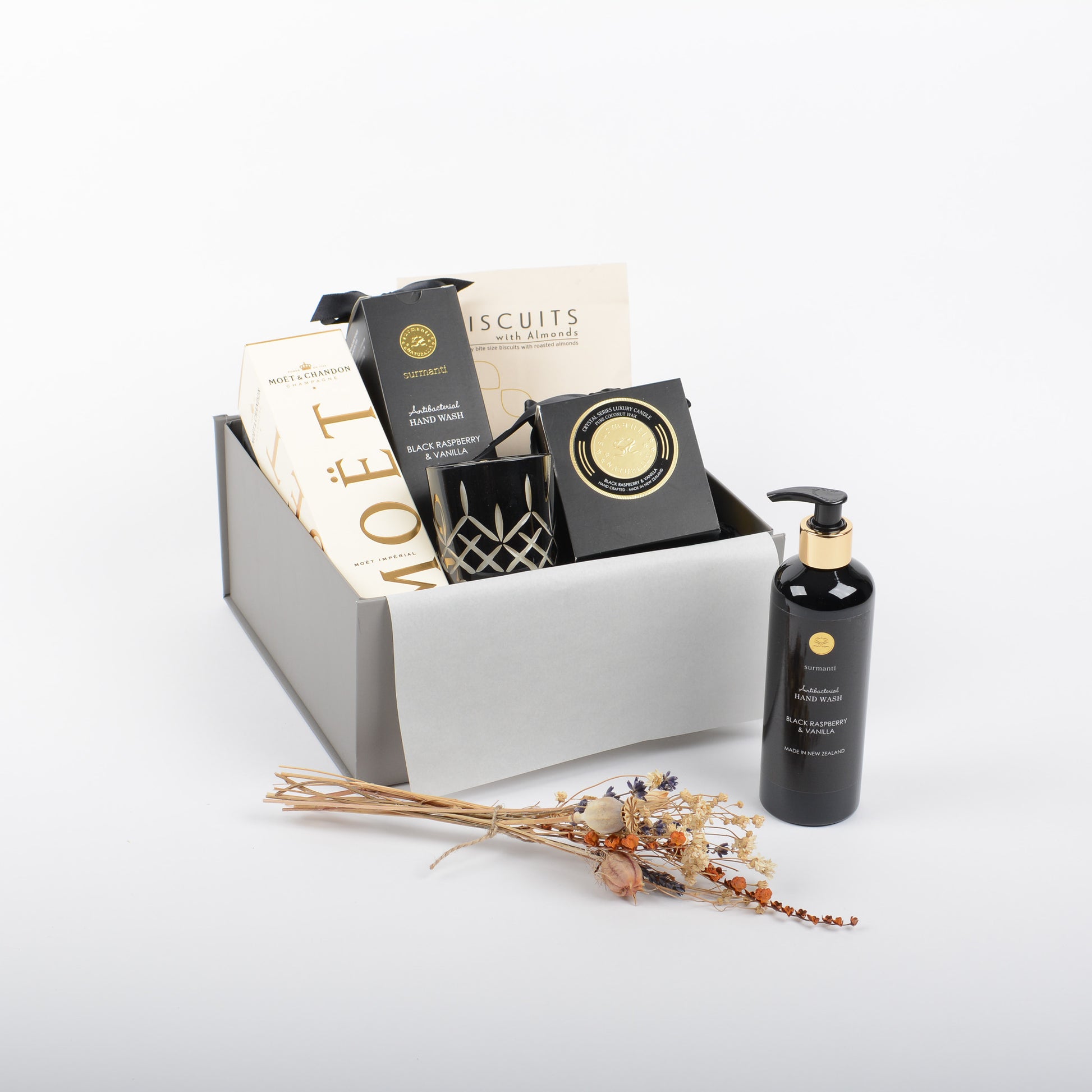 Premium products displayed in gift box. Luxury canlde and hand wash and moet bubbles.