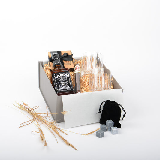 Gift basket with Jack Daniel's whiskey, glasses, and chocolate cigar and whisky stones.