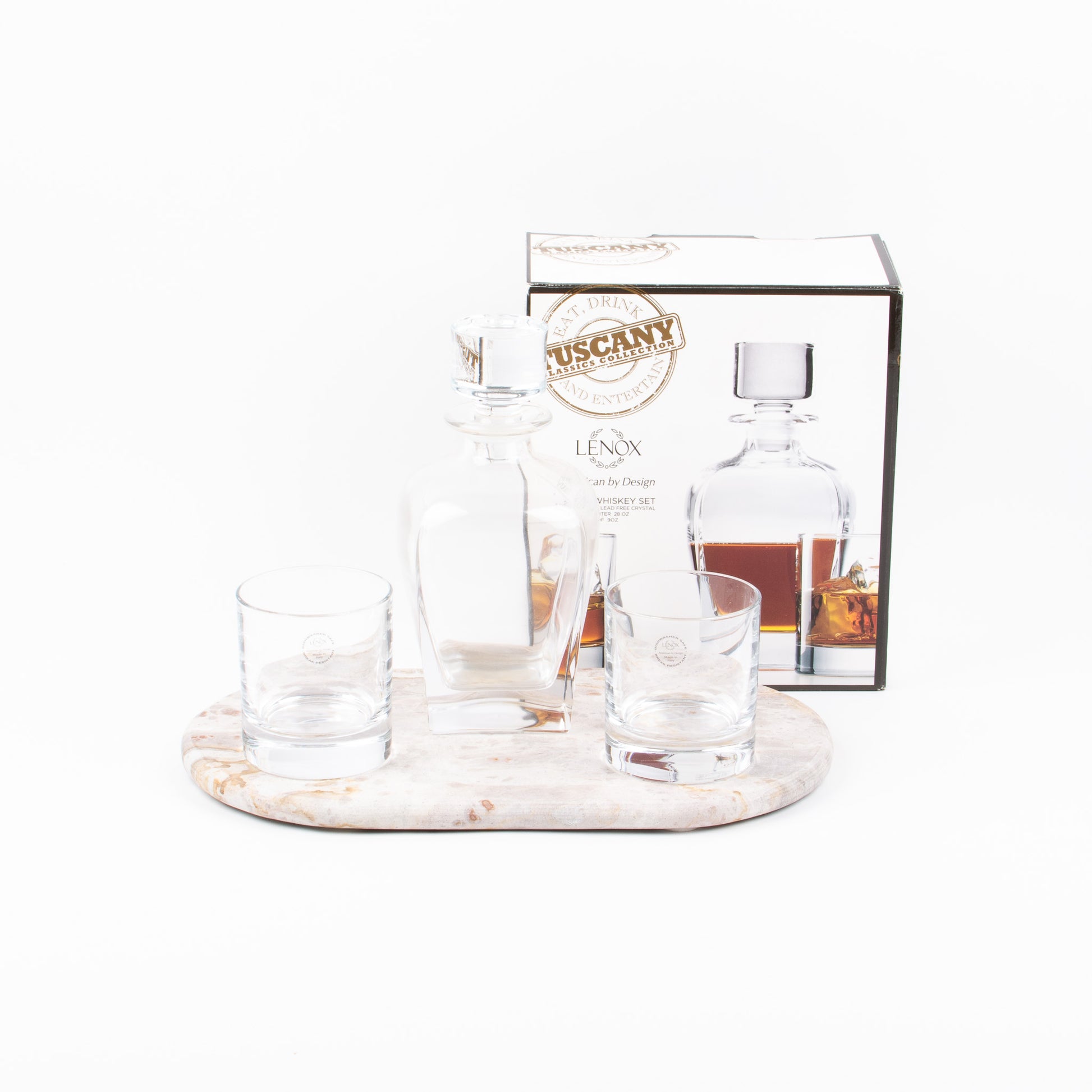 A Tuscany whisky 3 piece set with a decanter, two glasses, and a box packaging, displayed on a marble board (not included).