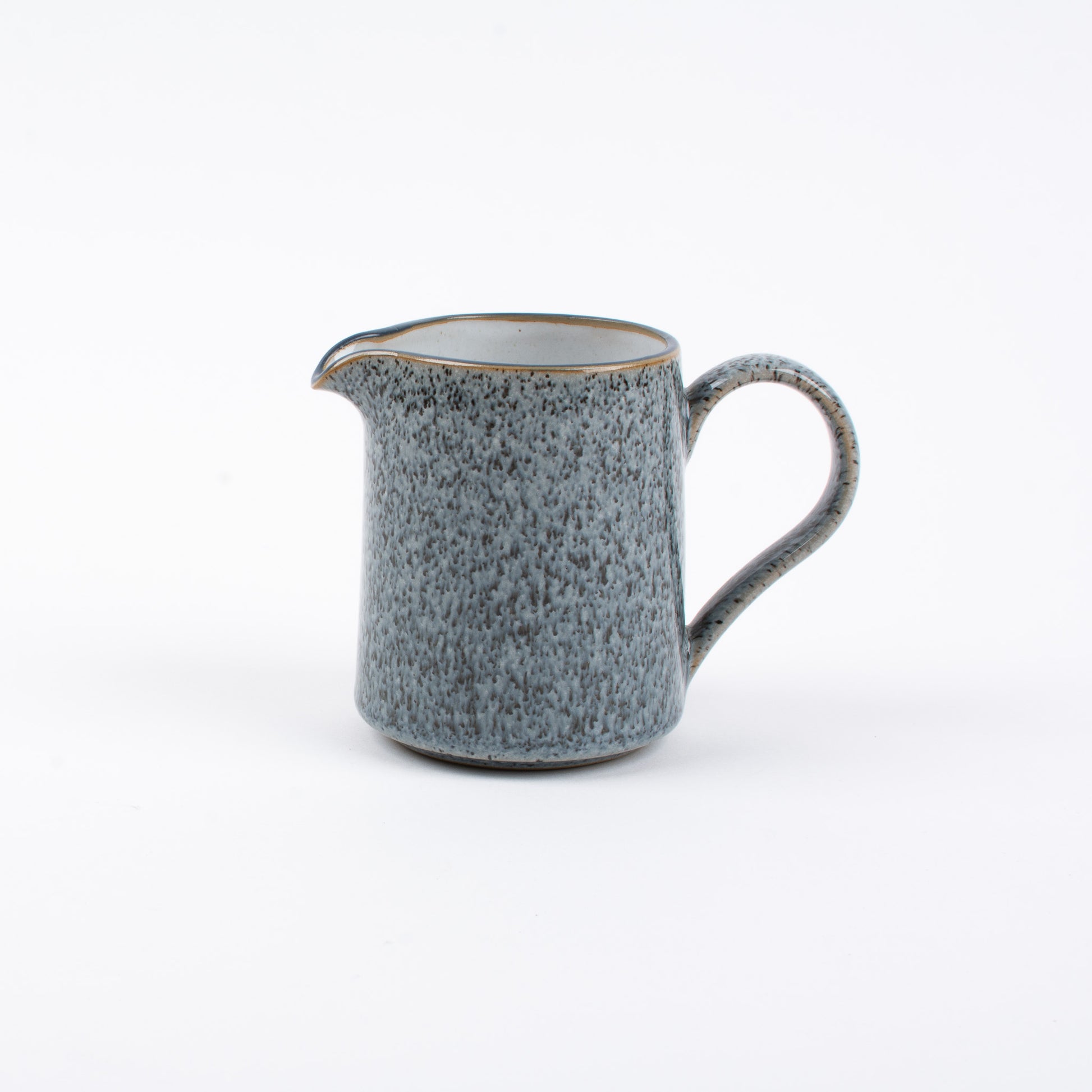 A blue Denby ceramic jug with a handle, placed against a white background.