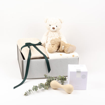 Luxury Blanket, swaddle by Mushie, rattle, tea, baby booties and soft toy inide of gift Box