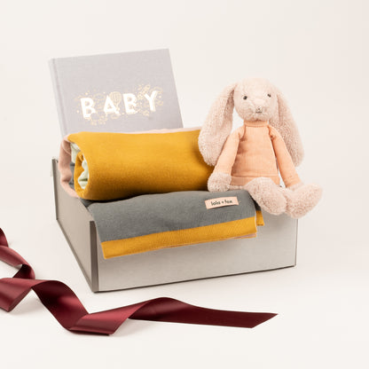 Luxury baby blanket, baby book and soft toy by Jellycat, diplayed inside of gift box.