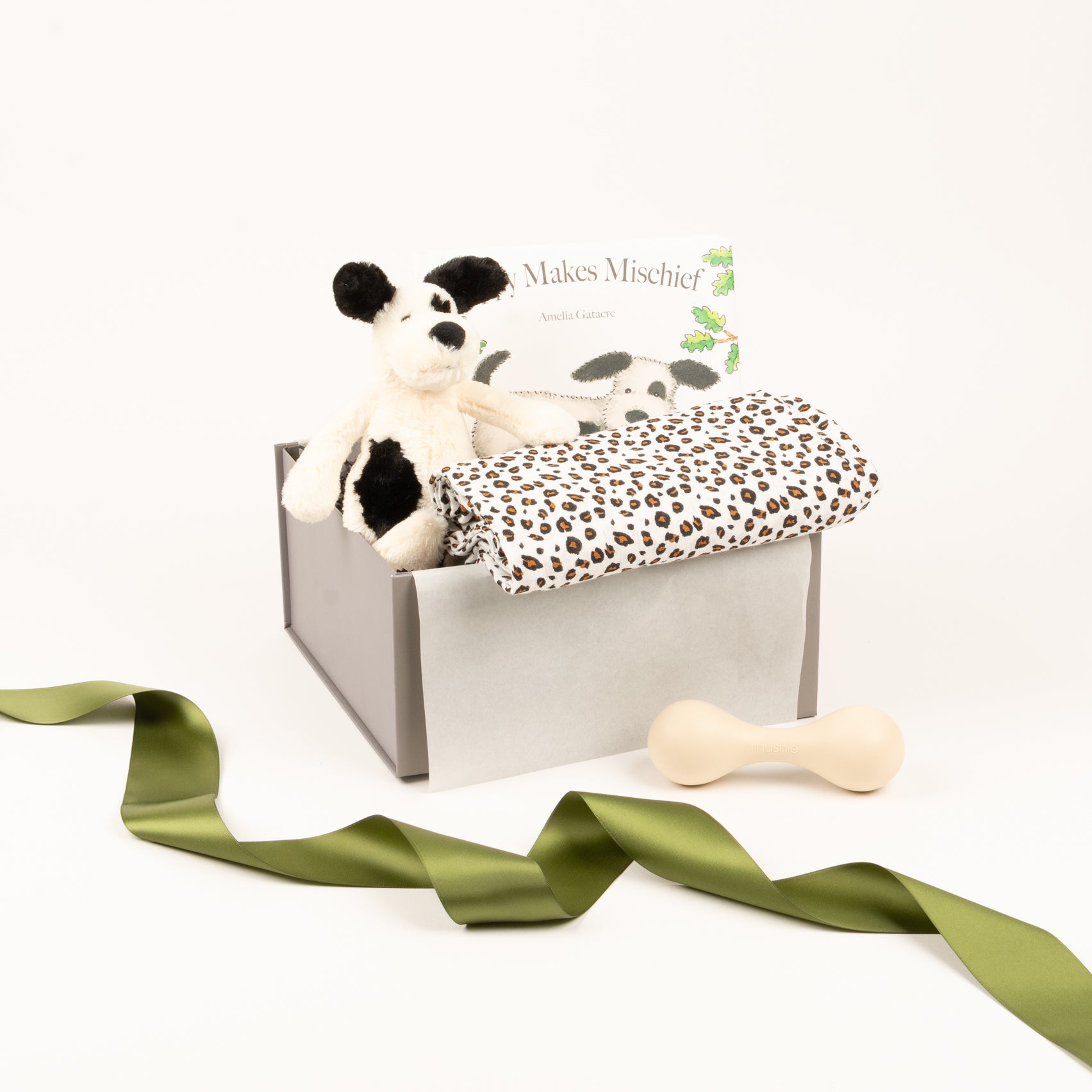 Sft toy by Jellycat, baby book, rattle and swaddle displayed inside of gift box.