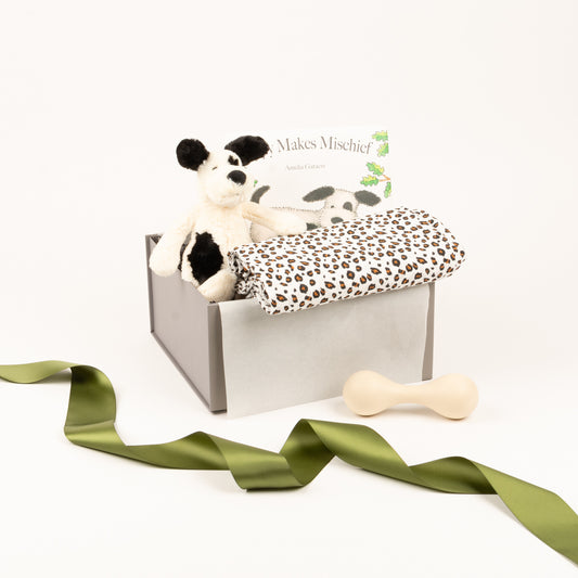 Sft toy by Jellycat, baby book, rattle and swaddle displayed inside of gift box.