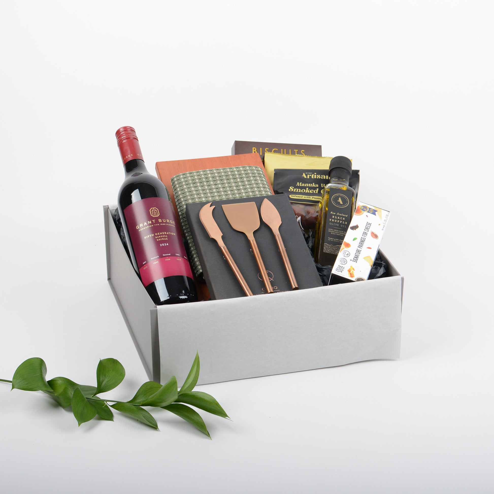Gift Box dislaying wine, cheese knife set, crafted cheeseboard and cotton tea towel, and artisan treats