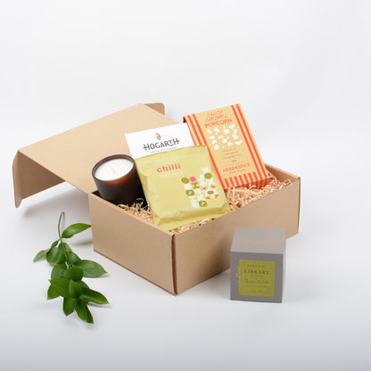 Featuring gourmet  popcorn, candle, chocolate, nuts in a kraft gift box.