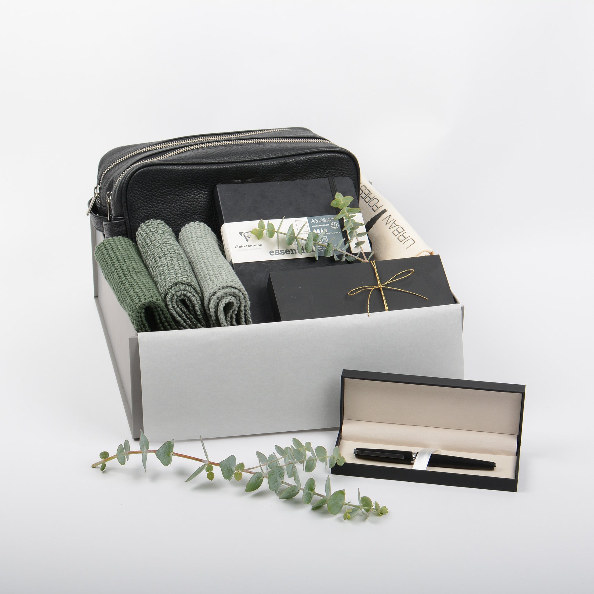 Featured in gift box is a leather wash bag, cotton wash cloths, journal and rollerball pen.