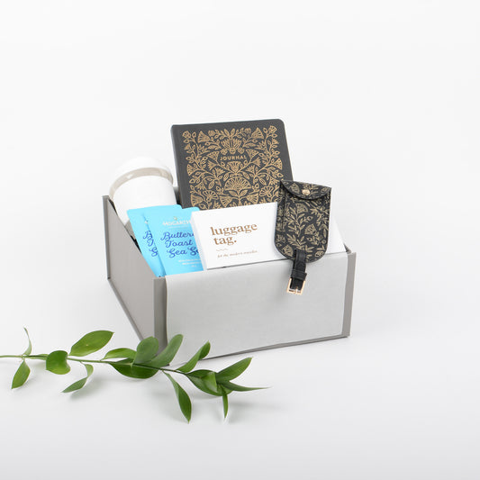 Gift Box features journal, luggage tag, chocolate and reusable cup.