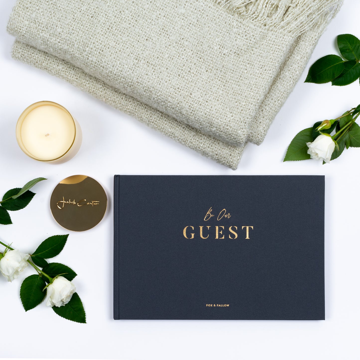 Out of Gift Box products are guest book, scented candle, soft throw.