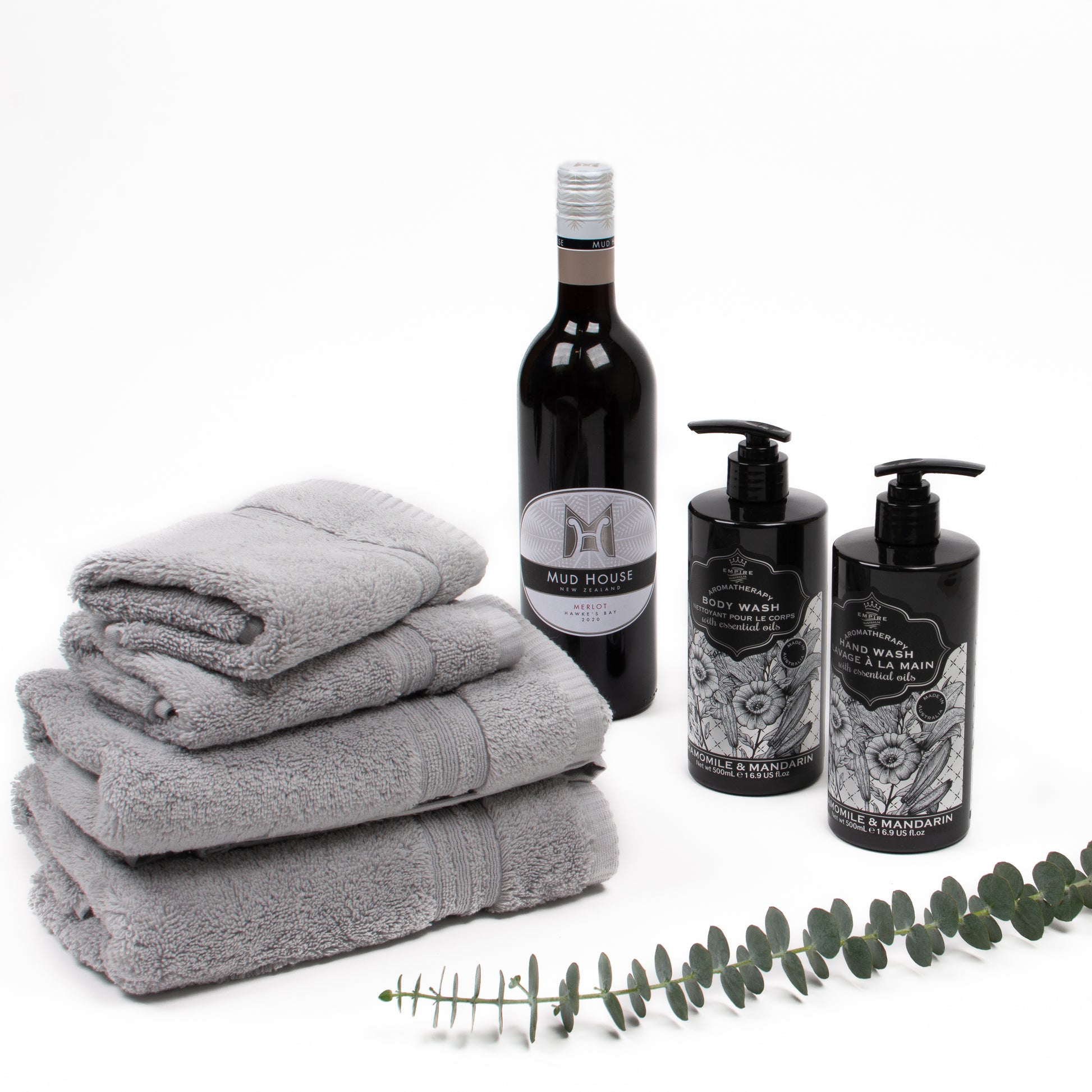 Products featured out of gift box are red wine, two hand towels and matching face cloths, hand wash, body wash.