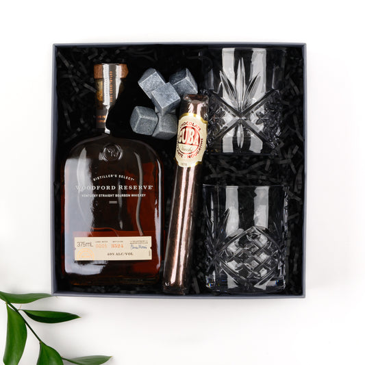 Gift box contains bourbon, two tumblers, Venchi cigar, whisky stones and pouch. 