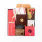 Gift box contains champagne, wooden board, cheese knife, linen tea towel, savoury biscuits, chocolate almonds, nuts, brownies.