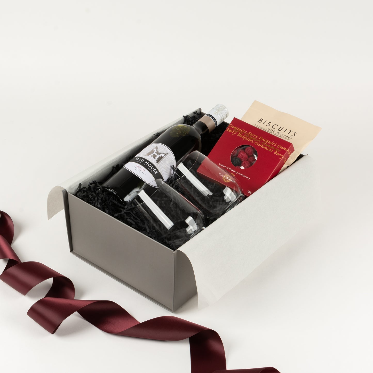 Included in this gift box is wine, stemless wine glasses, almond roasted biscuits and a sweet treat.