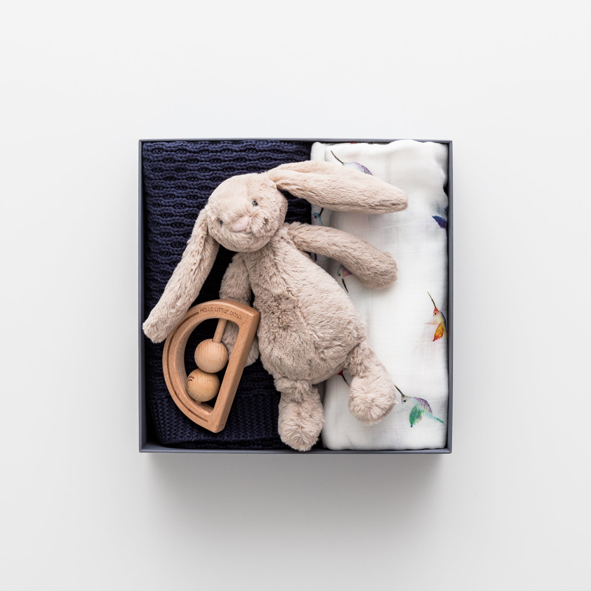 Gift box includes cotton blanket, wooden teether, bashful bunny.
