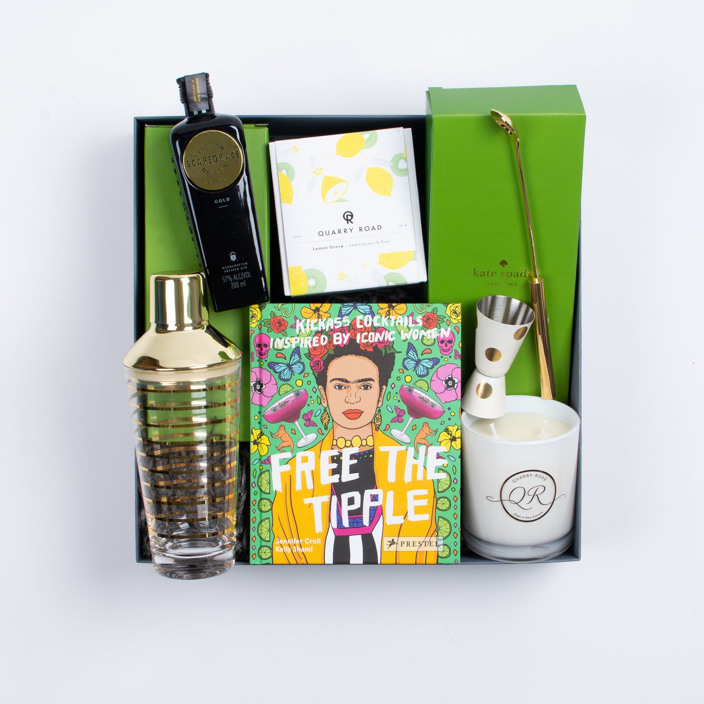 Gift box contains book, scented candle, scapegrace gin, cocktail shaker, spoon and jigger.