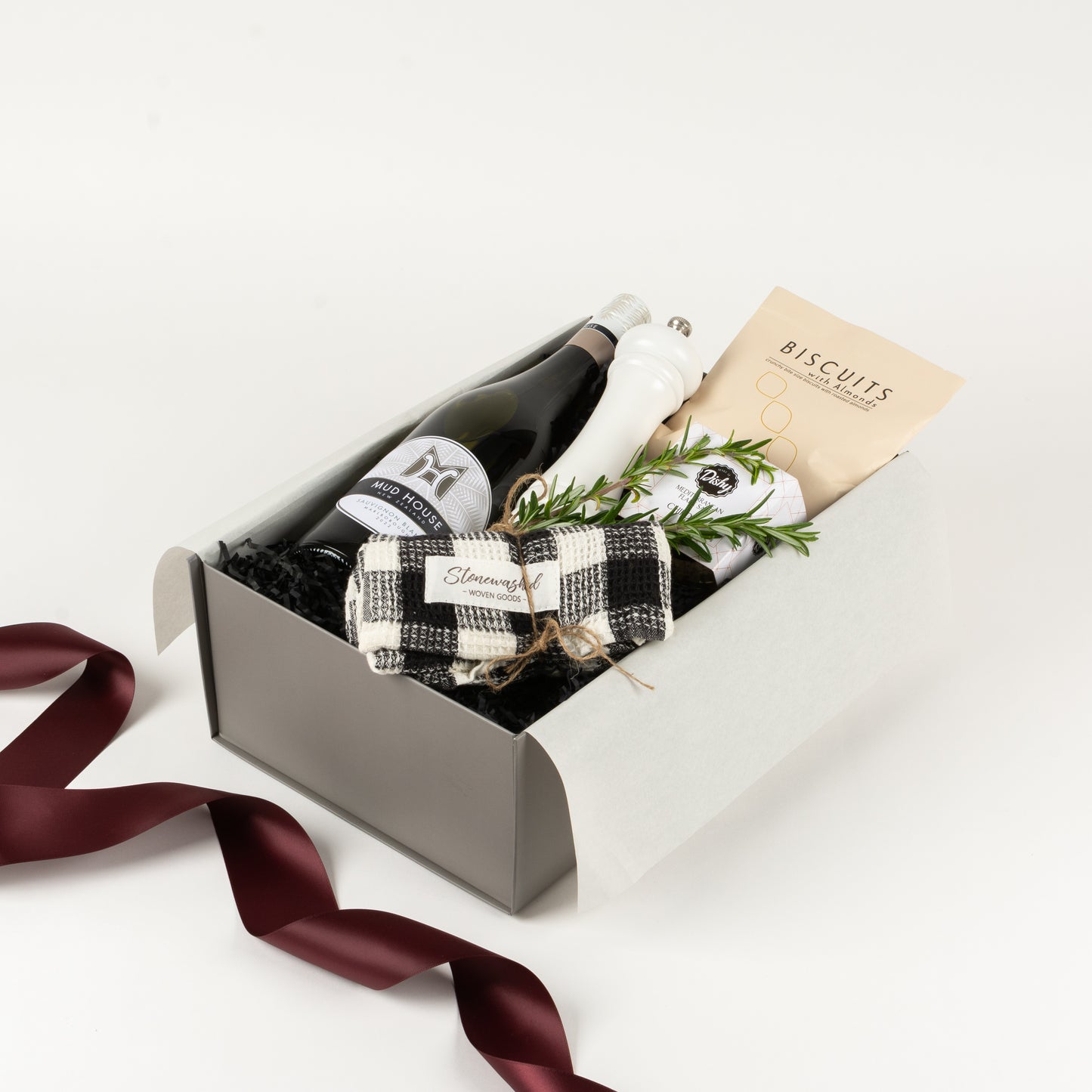 Featured in this gift box is wine, white pepper mill, gourmet salt, stonewashed cotton tea towel and almond biscuits.