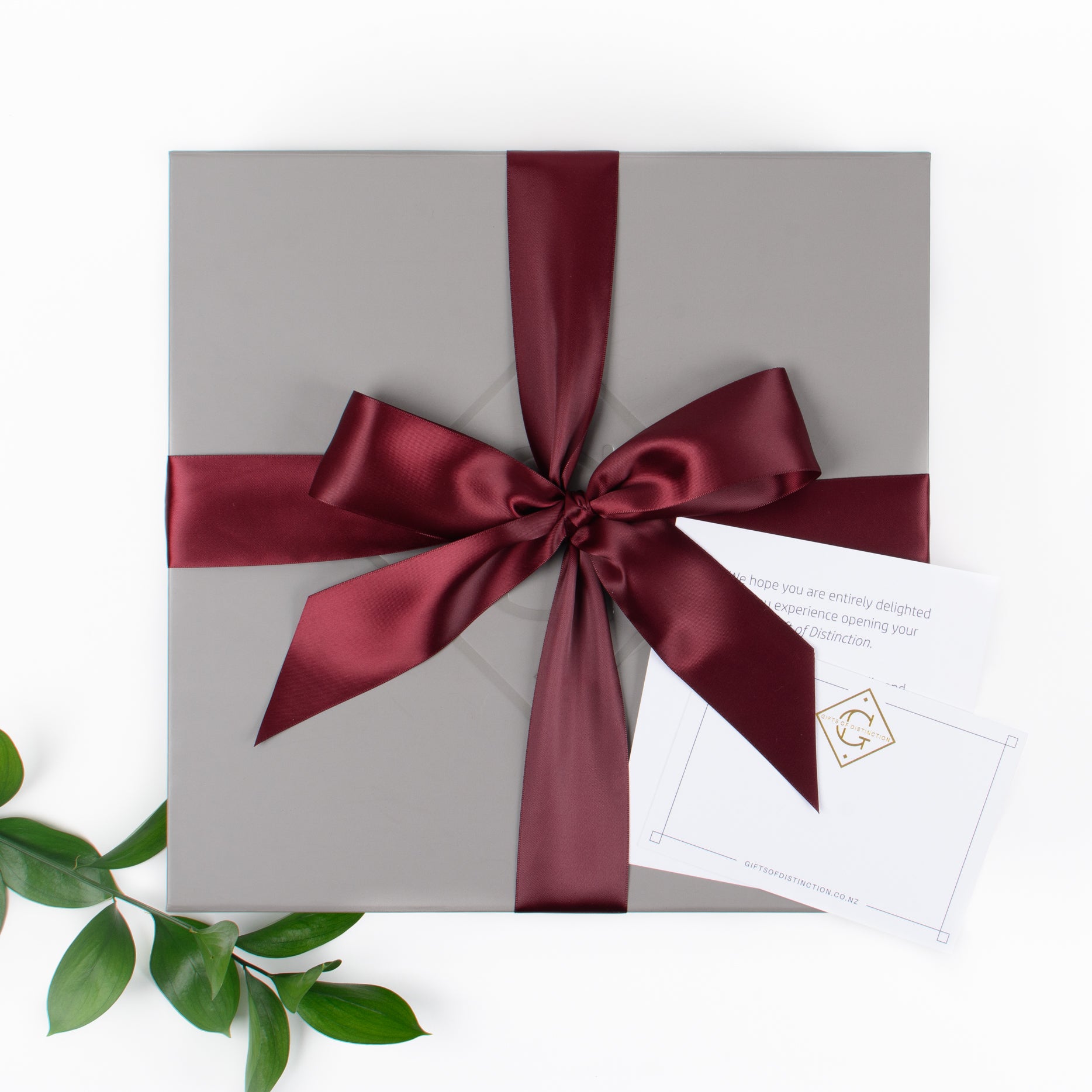 Grey gift box with satin ribbon and message card.
