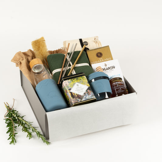 Eco Lovers Deluxe - Gift Boxes NZ - Gifts of Distinction.  Included is a set of organic cotton produce bags, cotton washers, reusable straws, drinking bottle and cup, herbal tea by Harney and sons, craft chocolate treats and artisan honey and dipper.