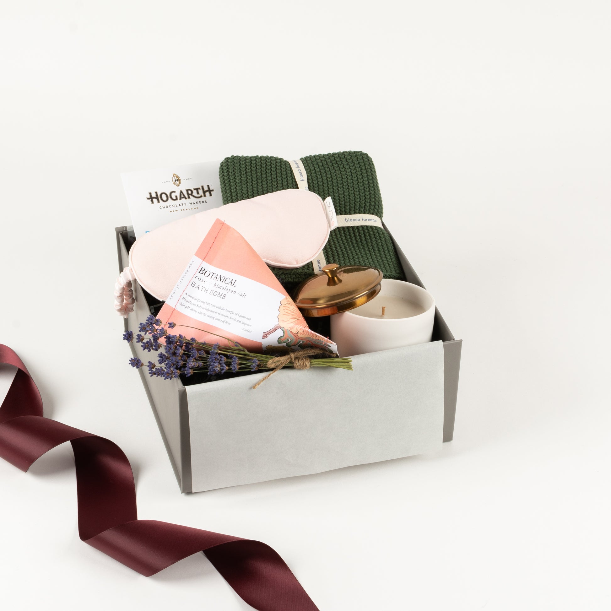  Included in this gift box is a cotton towel, linen eye mask, botanical bath bomb, candle and craft chocolate by Hogarth.
