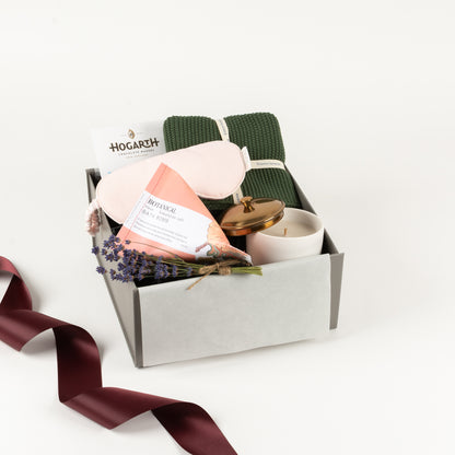  Included in this gift box is a cotton towel, linen eye mask, botanical bath bomb, candle and craft chocolate by Hogarth.